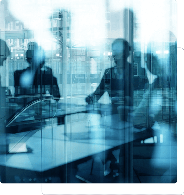 Blurred silhouettes of professionals in a modern office setting.