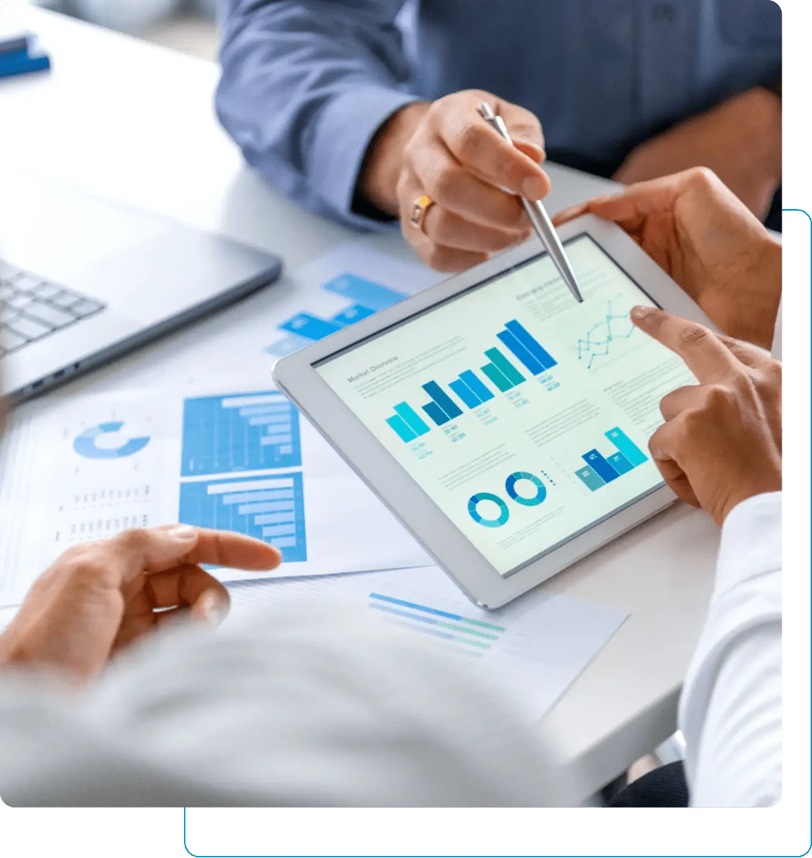 Two professionals reviewing financial data on a tablet with charts and graphs.